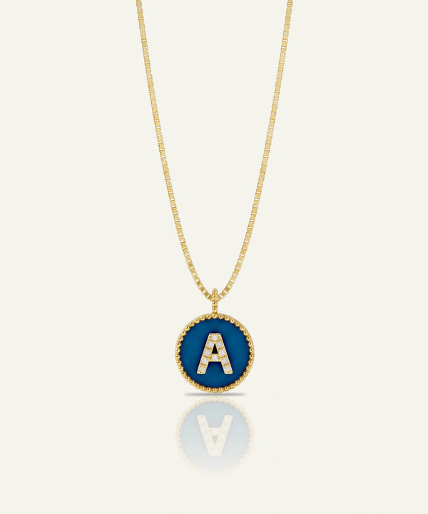 Green gummy bear charm with gold chain on a white background