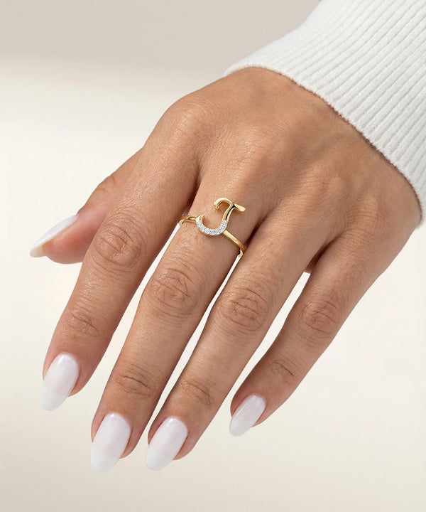 Hand wearing a gold ring with a white background