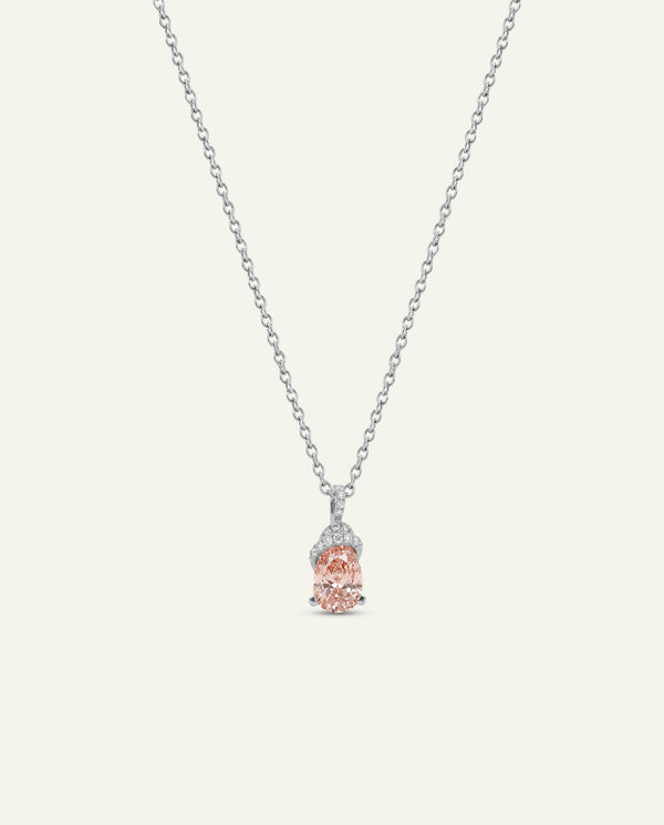 Silver pendant necklace featuring an oval light pink gemstone with clear stone accents, displayed on a solid off-white background