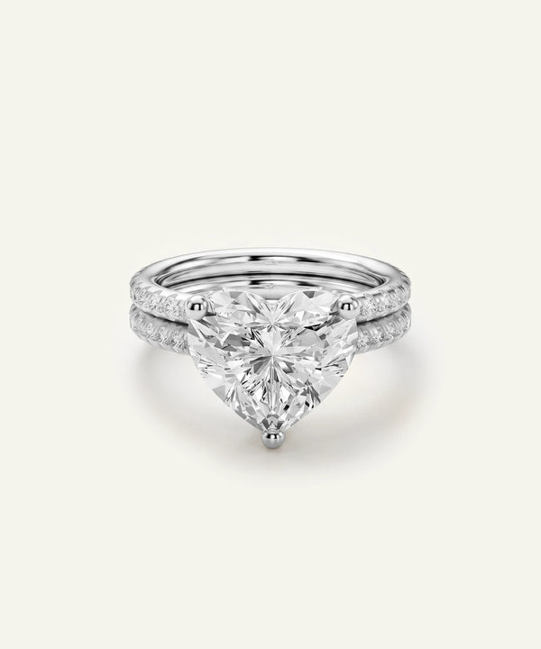 White gold heart-cut diamond engagement ring set with double pavé bands.
