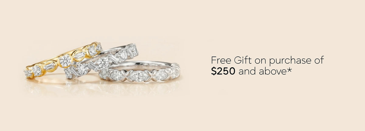 Three diamond rings on a beige background with text about a free gift offer.