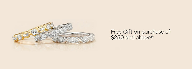 Three diamond rings on a beige background with text about a free gift offer.