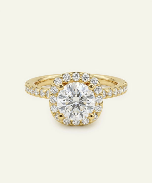 Gold ring with a large diamond and smaller diamonds around on a light beige background