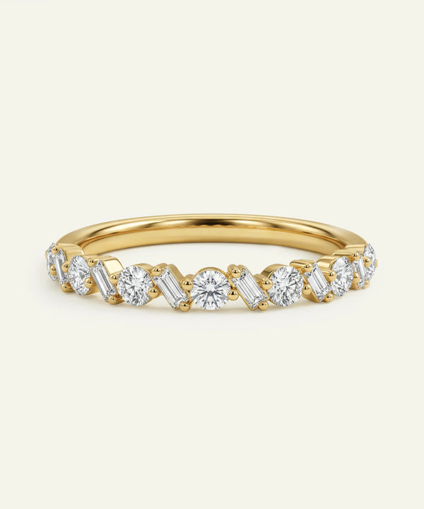 Gold band featuring alternating oval and baguette-cut diamonds on a neutral background