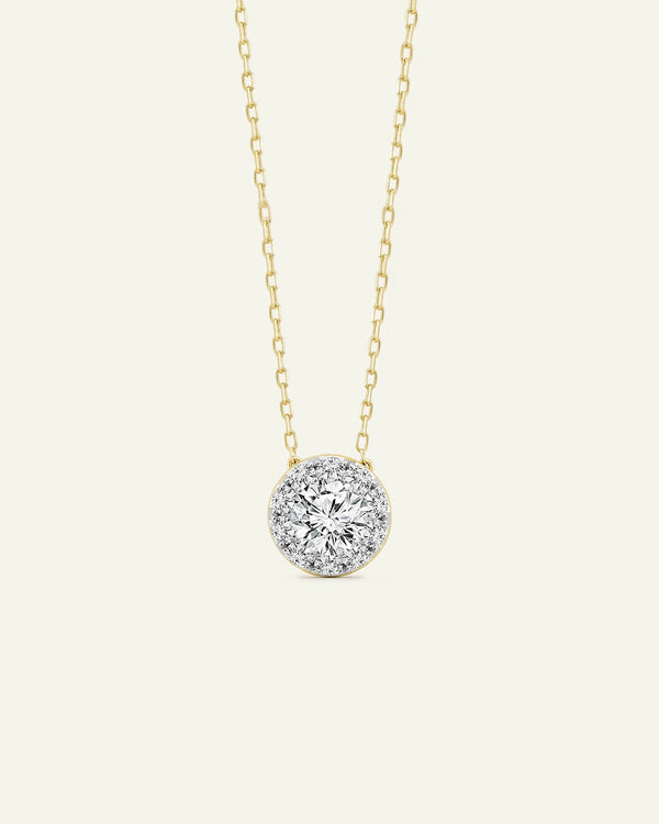 Gold necklace with a diamond pendant on a white background