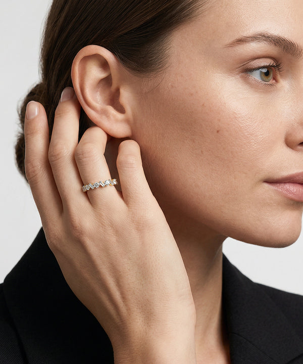 White gold band featuring alternating round and baguette-cut diamonds on a neutral background