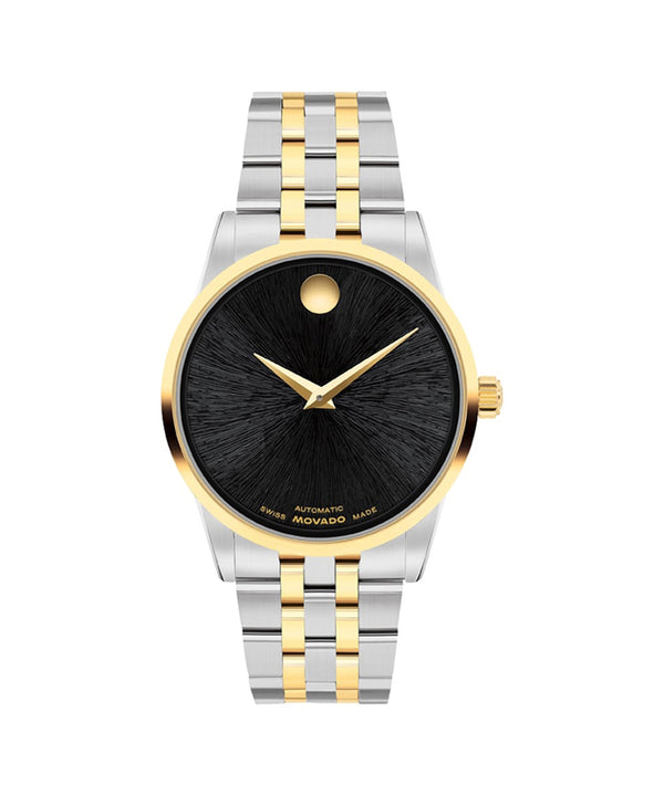 Two-tone watch with black face and gold accents on a white background