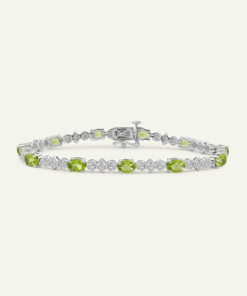 Peridot and diamond bracelet on a white background