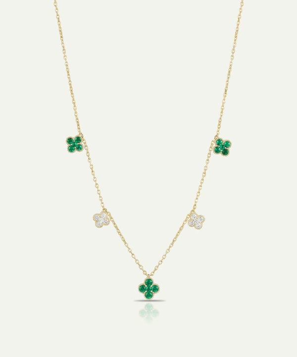 Gold necklace with green clover pendants on a white background