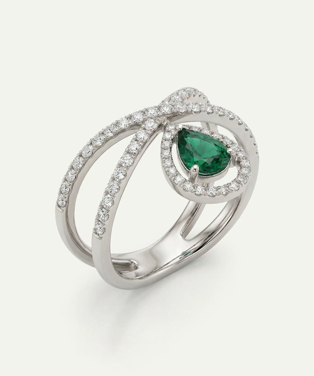 Silver ring with a green gemstone on a white background
