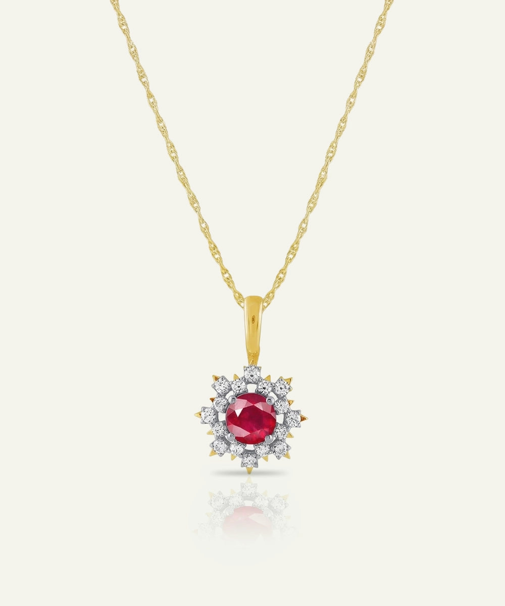 Gold necklace with a red gemstone pendant on a white background