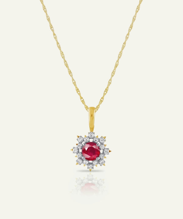 Gold necklace with a red gemstone pendant on a white background