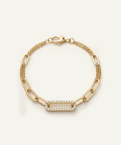 Gold bracelet with a diamond-studded bar on a white background