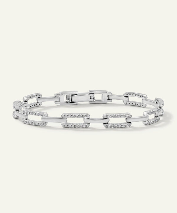 Silver bracelet with chain links on a light gray background