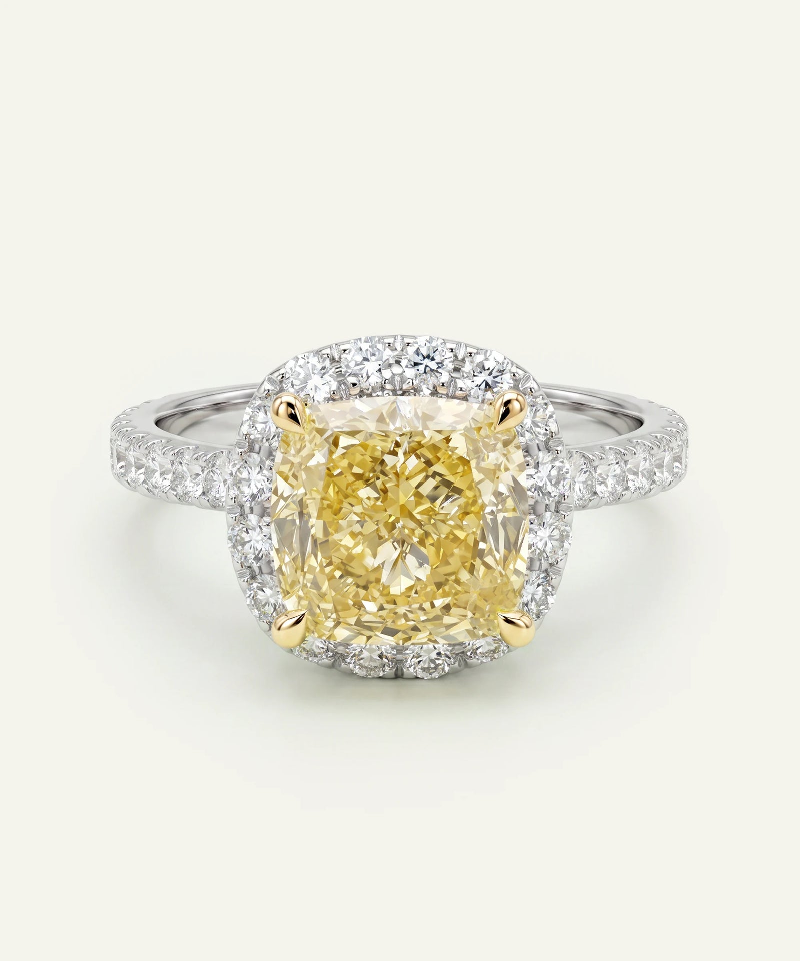 Diamond ring with a yellow center stone on a white background