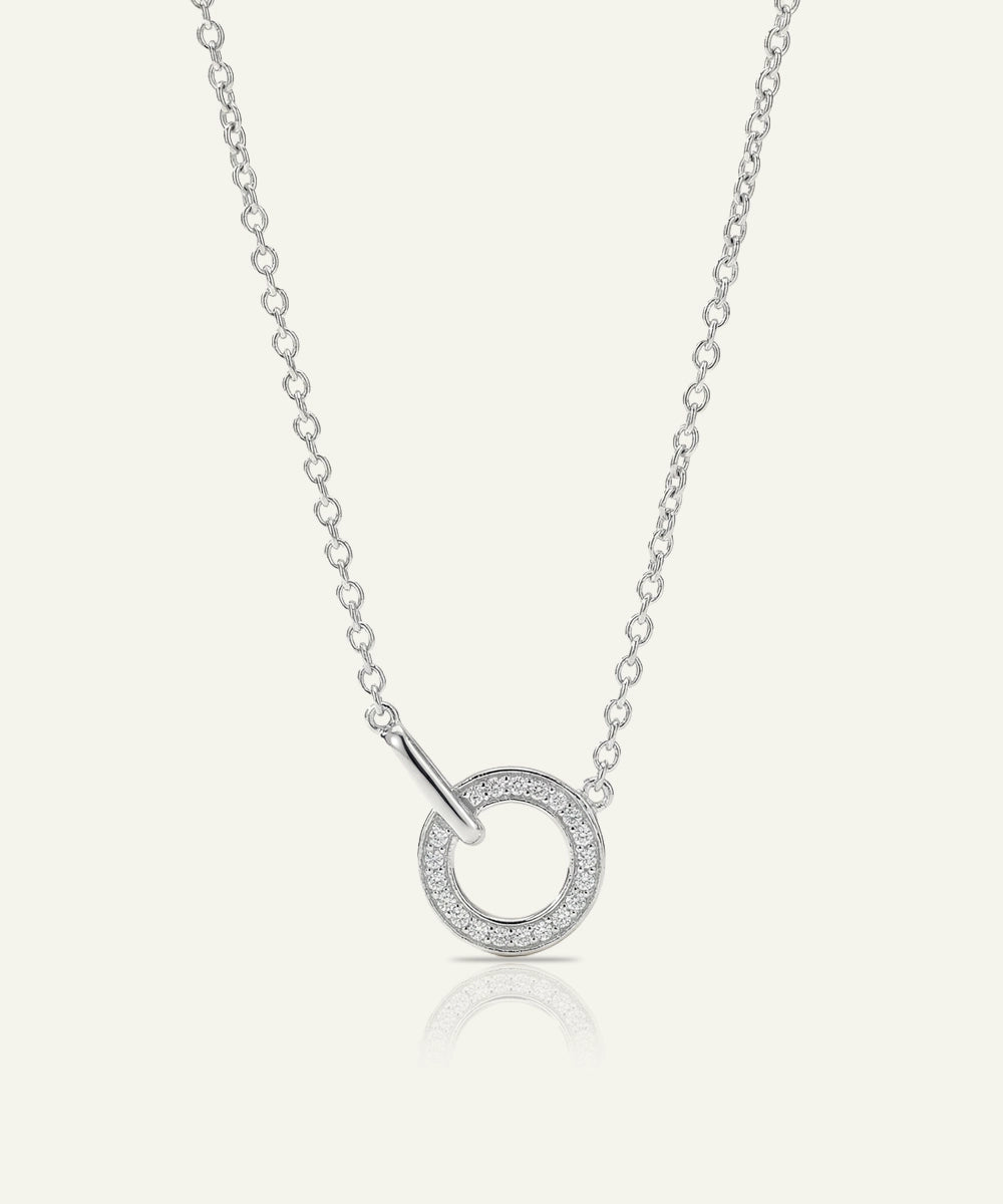 Silver necklace with a circular pendant on a white background