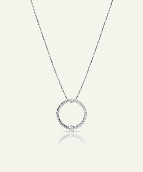 Silver necklace with a round pendant on a white background