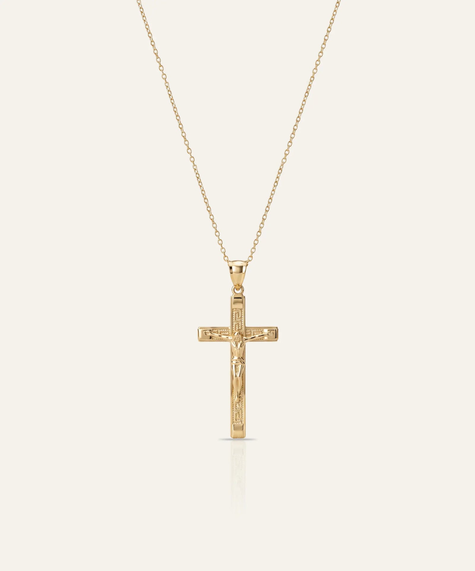 Silver necklace with a clover-shaped pendant on a light gray background