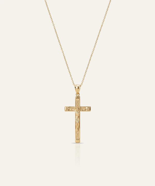 Silver necklace with a clover-shaped pendant on a light gray background