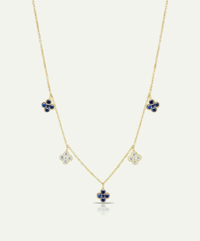 Gold necklace with floral pendants on a white background