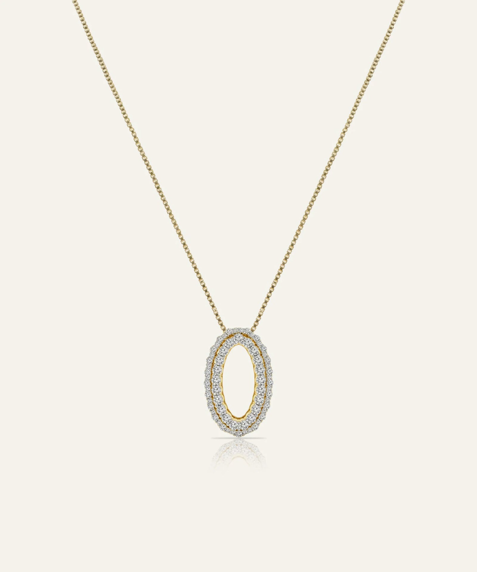 Gold necklace with a diamond pendant on a light gray background