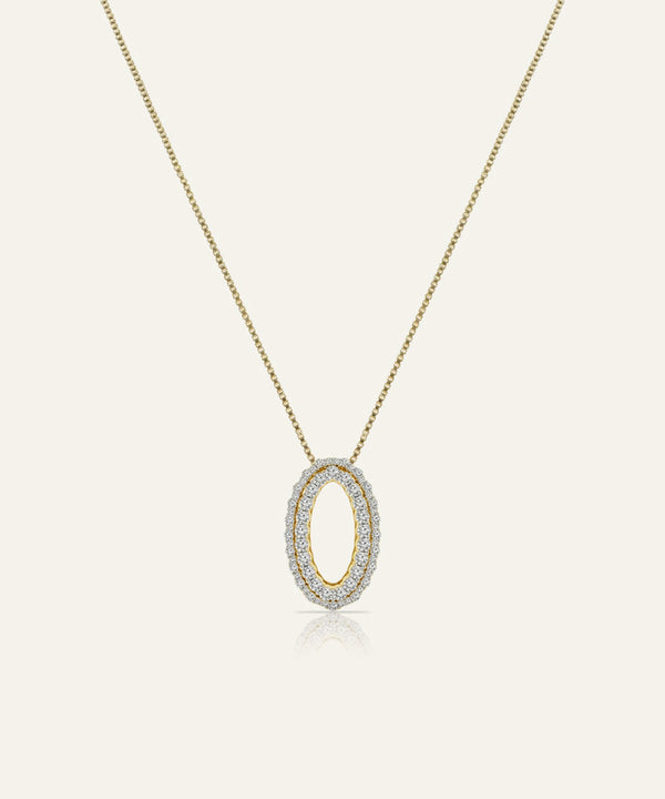 Gold necklace with a diamond pendant on a light gray background