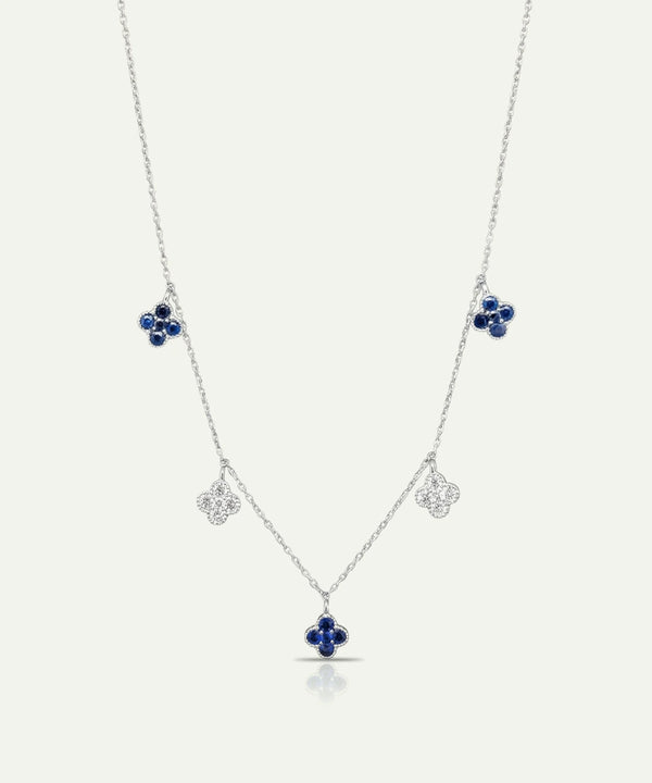 Silver necklace with blue gemstone pendants on a white background