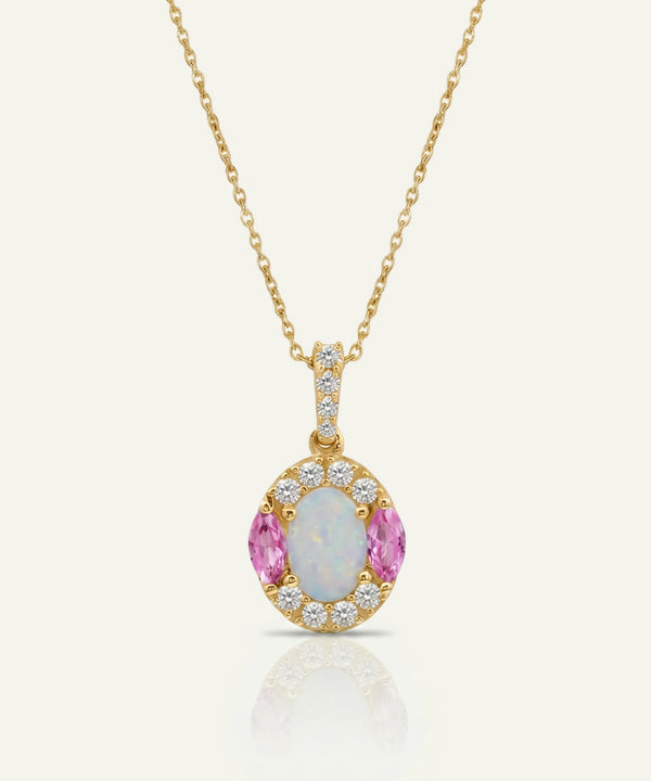 Gold necklace with a pendant featuring pink gemstones and diamonds on a white background