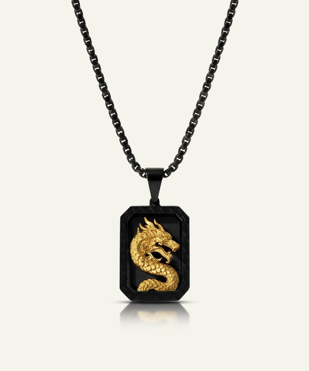 Black and gold dragon pendant necklace on a white background