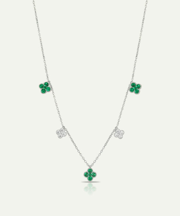 Silver necklace with green gemstone pendants on a white background