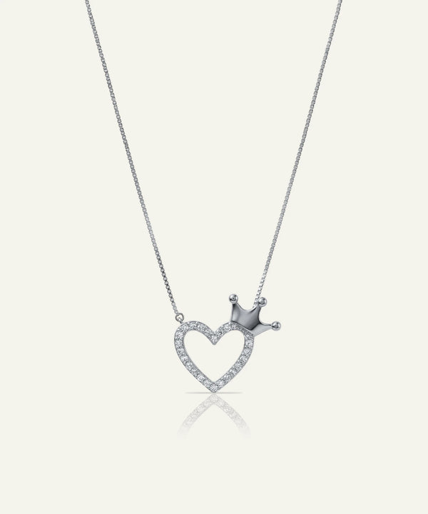 Silver necklace with a heart-shaped pendant and crown on a white background