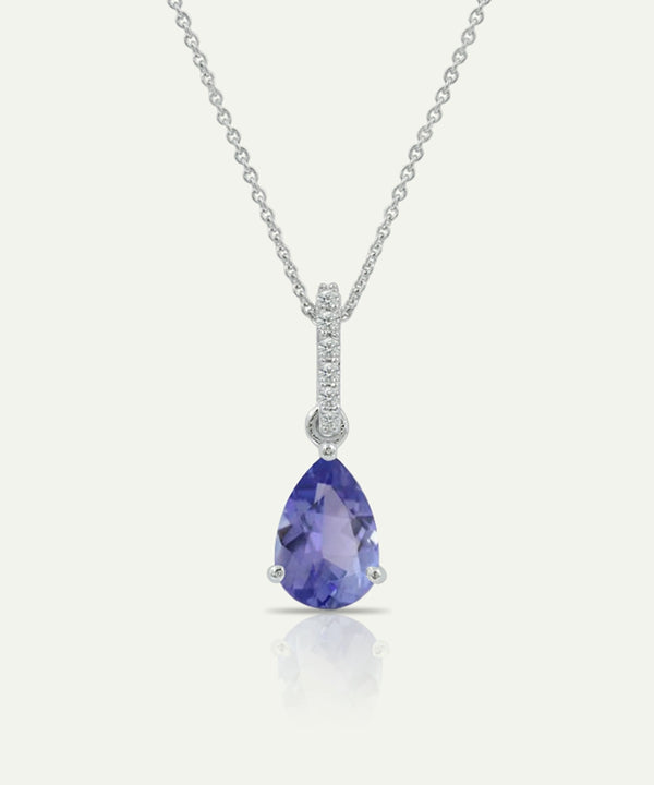 Teardrop-shaped purple gemstone pendant on a silver chain against a white background