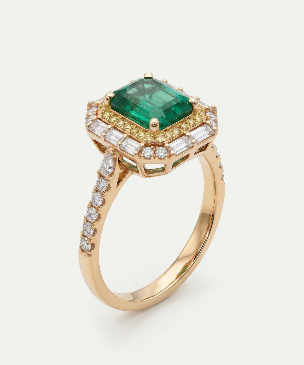 Gold ring with a green gemstone and diamond accents on a white background