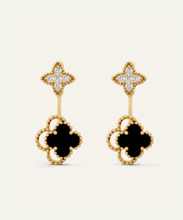 Pair of silver hoop earrings with green gemstones on a white background