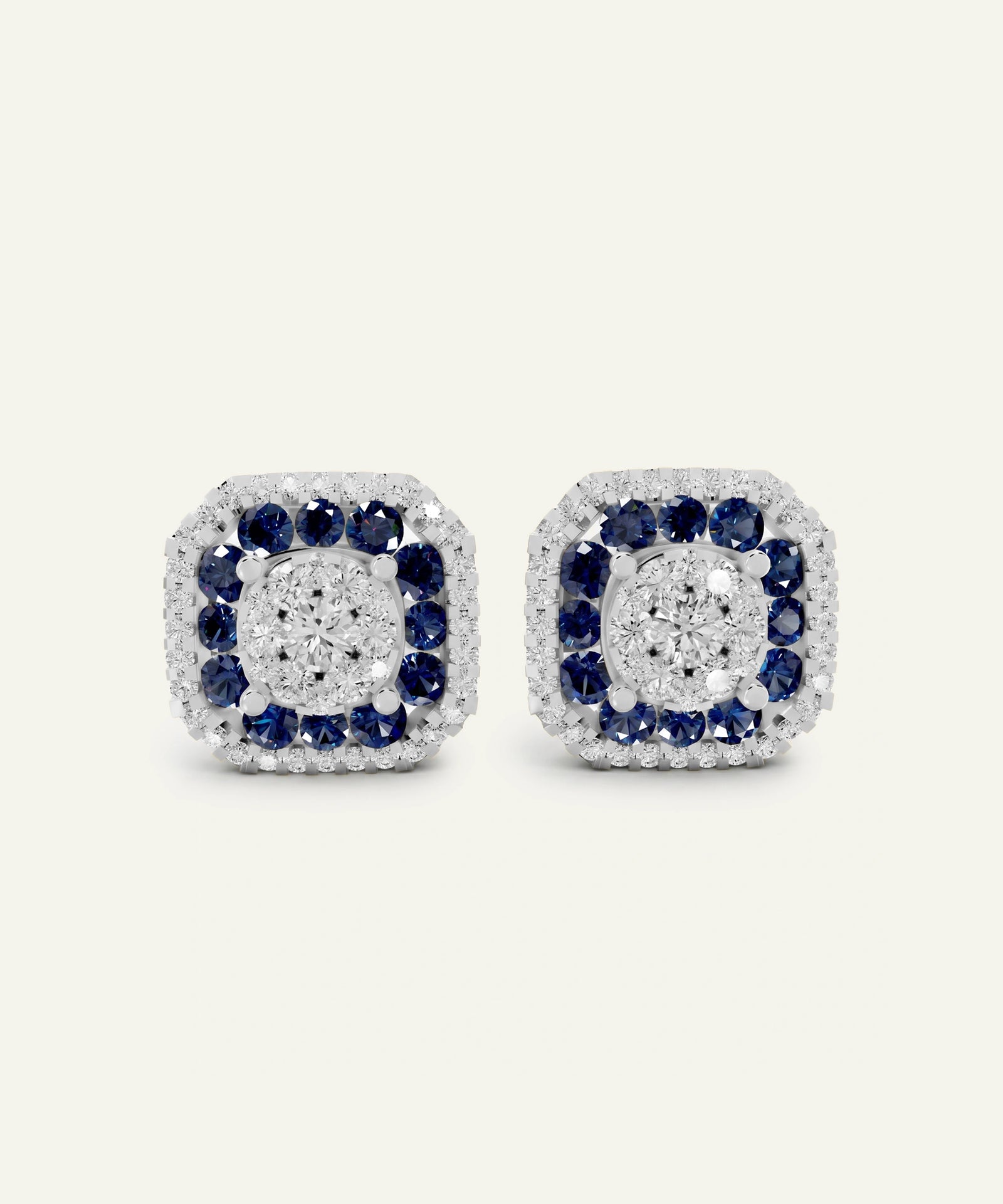 A pair of square-shaped stud earrings featuring a double halo design. The center of each earring is filled with round brilliant-cut diamonds, surrounded by a halo of small clear stones, and bordered by a ring of deep blue sapphires, all set in a white metal.