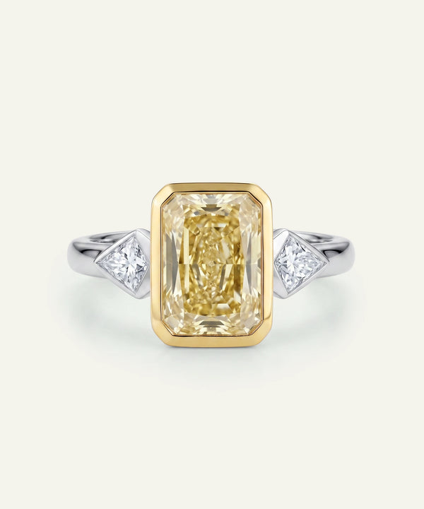 Gold ring with a large diamond and smaller diamonds on a white background