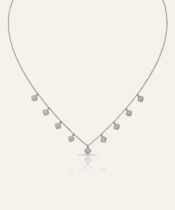 Silver necklace with small diamonds on a light gray background