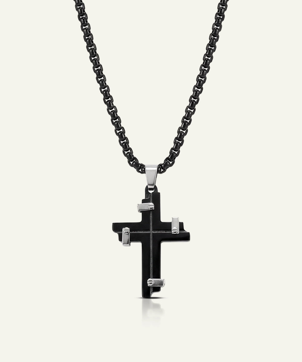 Black cross pendant necklace on a white background