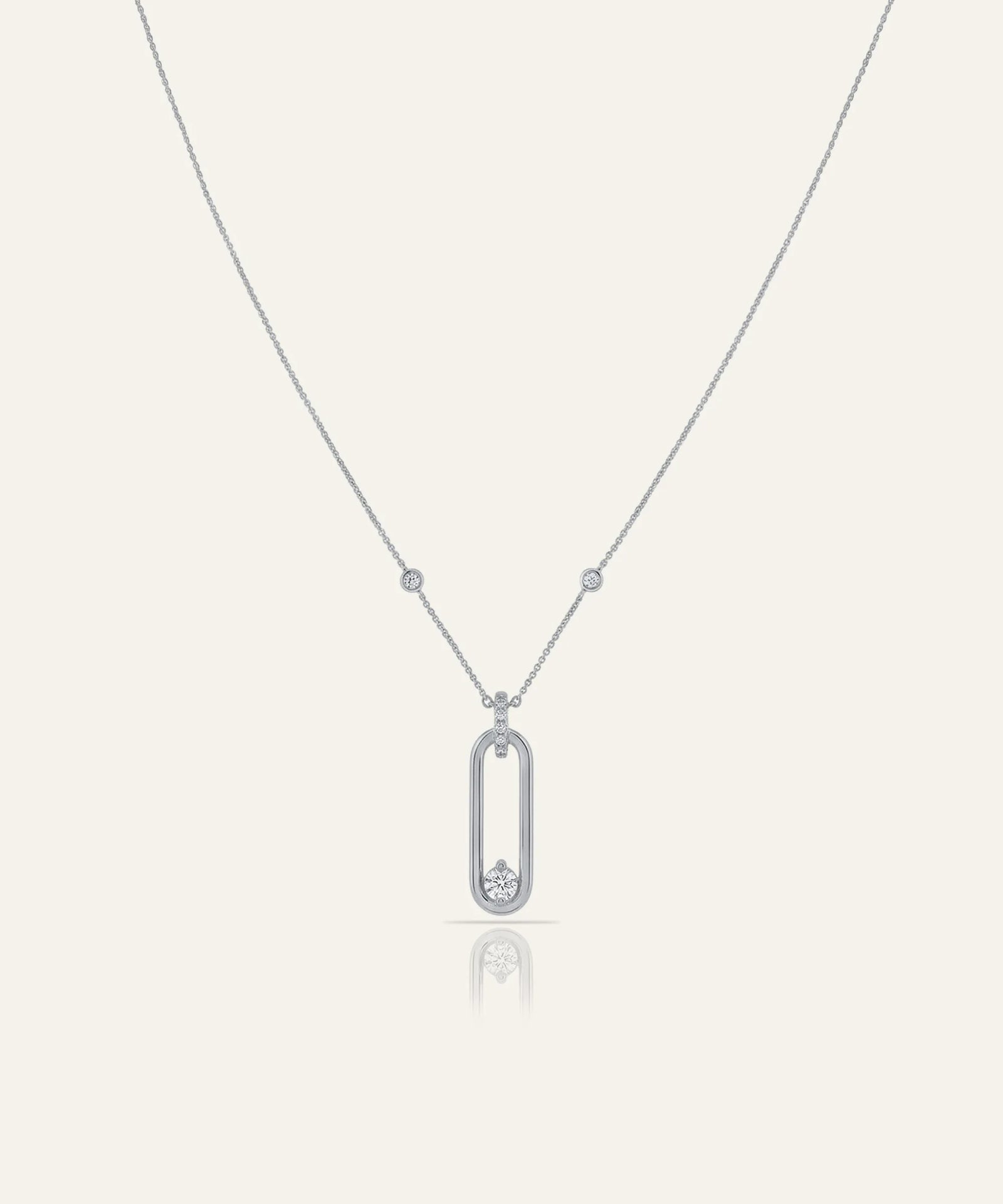 Silver necklace with a pendant on a light gray background