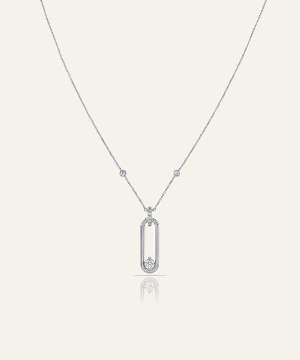 Silver necklace with a pendant on a light gray background