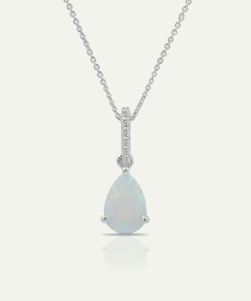Teardrop-shaped opal pendant with diamond accents on a white background