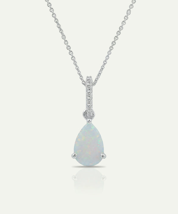 Teardrop-shaped opal pendant with diamond accents on a white background