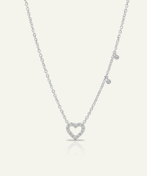 Silver heart-shaped pendant necklace on a white background