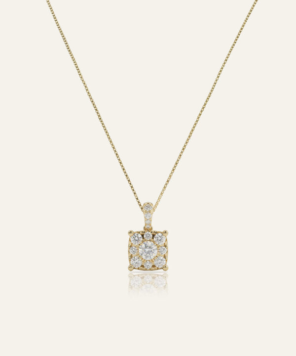 Gold necklace with a square diamond pendant on a light beige background