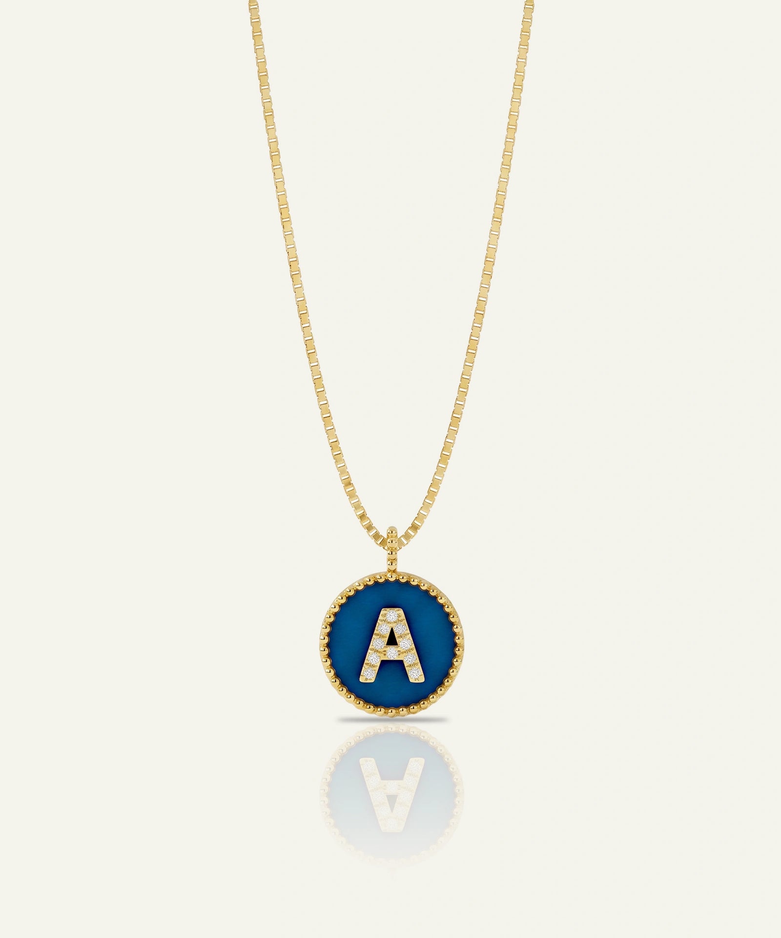 Green gummy bear charm with gold chain on a white background