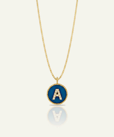 Green gummy bear charm with gold chain on a white background