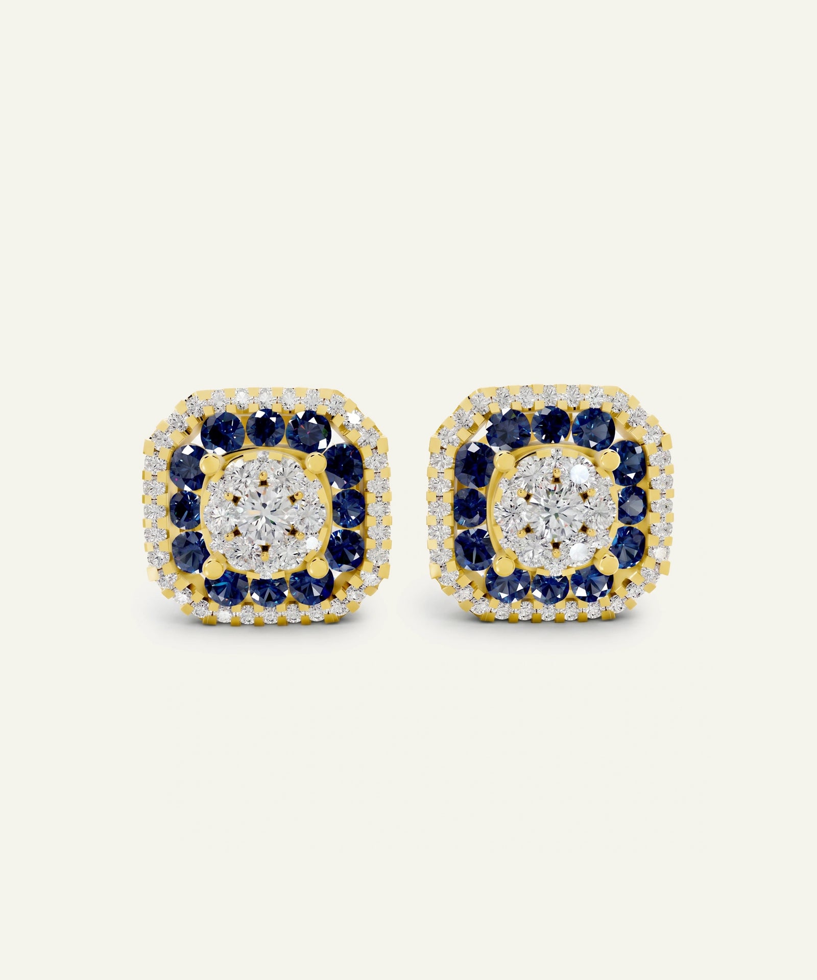 A pair of square cluster stud earrings in yellow gold, featuring a central round clear gemstone surrounded by a halo of round blue sapphires and small clear stones, set against a plain off-white background.