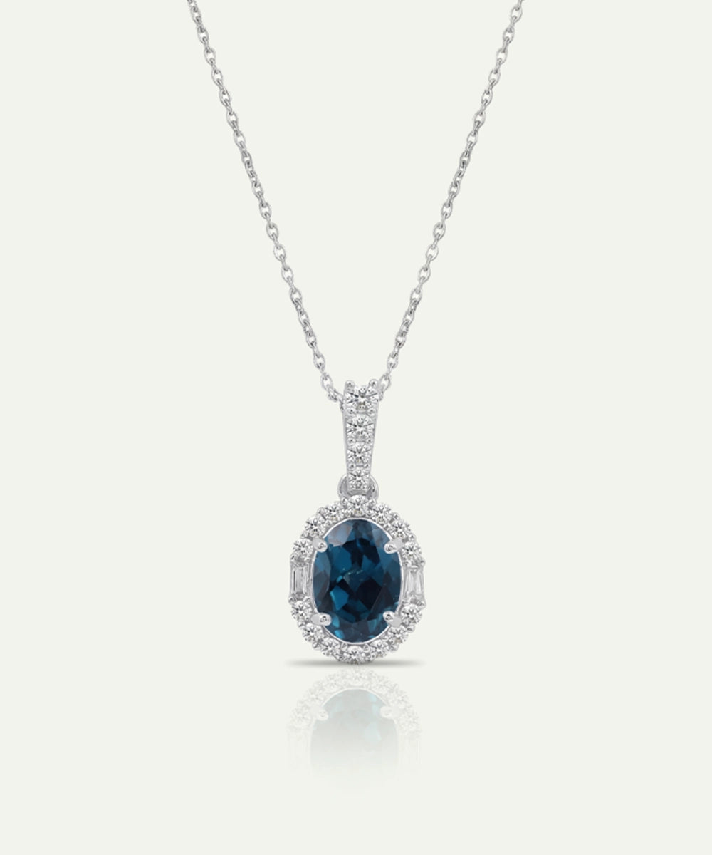 Ruby pendant on a silver chain against a white background