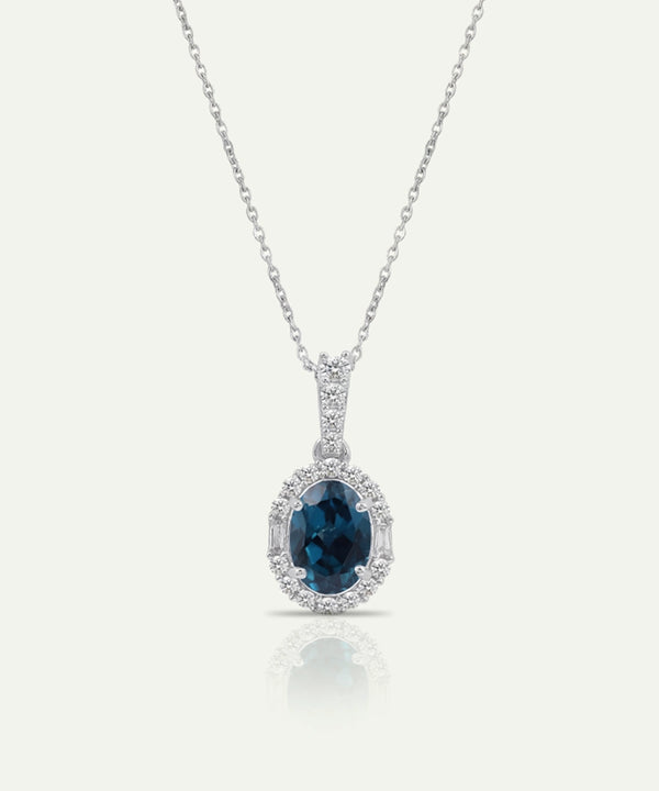 Ruby pendant on a silver chain against a white background