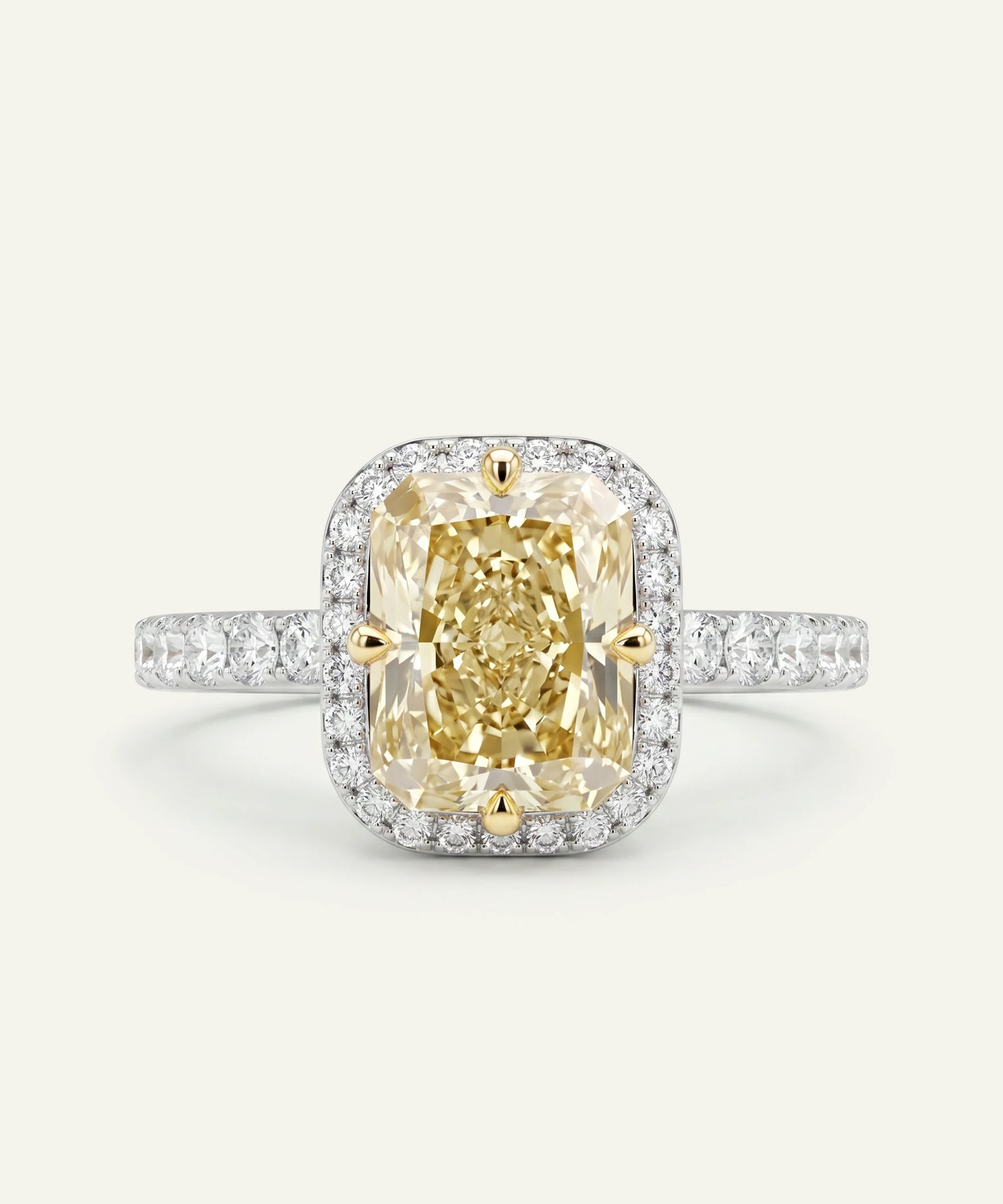 Diamond ring with a yellow gemstone on a light gray background